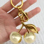 Golden Cherry Keychain Charm - Shiny Resin & Metal Bag Accessory, Elegant Gift tion